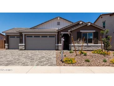 Inviting single-Gathering home featuring a neutral color palette, paver driveway and walkway, and a two-car garage at 12366 W Marguerite Ave, Avondale, AZ 85323