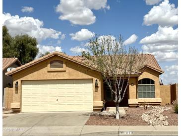 Charming single-story home featuring a well-manicured yard and a two-car garage at 1314 W Kingbird Dr, Chandler, AZ 85286