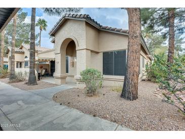 Charming single-story home with a stucco exterior, arched entryway, and low-maintenance landscaping at 14300 W Bell Rd # 245, Surprise, AZ 85374