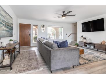 Inviting living room features stylish decor, modern ceiling fan, and neutral paint tones at 16336 E Palisades Blvd # 7, Fountain Hills, AZ 85268