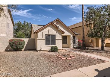Charming single-story home featuring desert landscaping and a quaint front yard at 16513 N 68Th Dr, Peoria, AZ 85382
