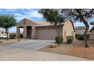 Charming single-story home with a low-maintenance landscaped front yard and an attached two-car garage at 17151 W Mohave St, Goodyear, AZ 85338