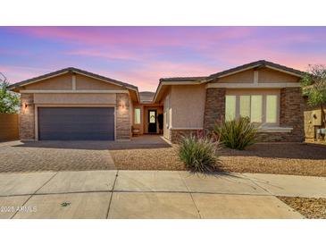 Charming single-story home with stone accents, desert landscaping, and a welcoming front entrance at 22434 S 226Th Pl, Queen Creek, AZ 85142