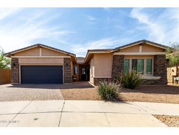Charming single-Gathering home featuring stone accents, neutral tones, and a two-car garage at 22434 S 226Th Pl, Queen Creek, AZ 85142
