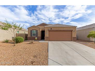 Charming single-story home with a neutral color palette, desert landscaping, and a two-car garage at 30993 W Indianola Ave, Buckeye, AZ 85396