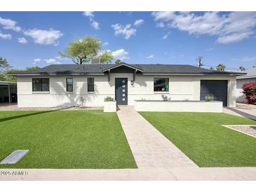 Charming single-story home featuring a well-manicured lawn and a welcoming walkway leading to the front door at 4602 N 74Th Pl, Scottsdale, AZ 85251