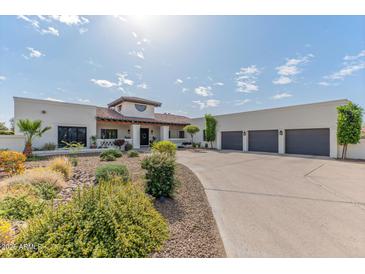 Expansive single-story home with a four-car garage and beautiful desert landscaping at 4617 E Elmwood Cir, Mesa, AZ 85205