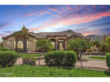 Beautifully landscaped single-story home with a tiled roof and mountain views at 5523 W Creekside Ln, San Tan Valley, AZ 85144