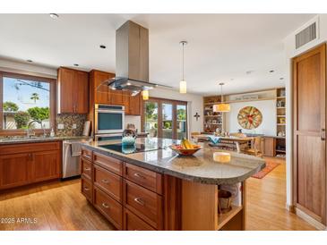 Chef's kitchen featuring custom cabinetry and a large island for entertaining at 6122 E Harvard St, Scottsdale, AZ 85257