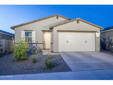 Charming single-story home features a two-car garage and low maintenance landscaping at 6732 W Pedro Ln, Laveen, AZ 85339