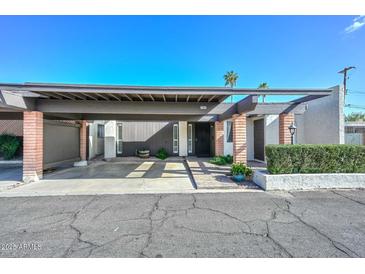 Inviting home exterior with covered parking and desert landscaping at 1216 E Ormondo Way, Phoenix, AZ 85014