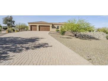 Stunning home featuring a paver driveway and three-car garage for ample parking space at 17324 E Quail Track Rd, Rio Verde, AZ 85263