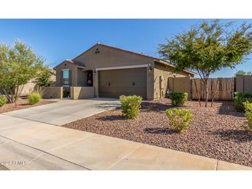 Charming single-story home featuring a desert-landscaped front yard and a two-car garage at 17971 W Meadowbrook Ave, Goodyear, AZ 85395
