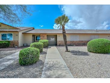 Charming single-story home with well-maintained landscaping and a quaint walkway at 18610 N Mica Dr, Sun City West, AZ 85375