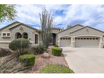 Charming single-story home featuring a well-manicured front yard with desert landscaping and an attached two-car garage at 2600 E Hazeltine Way, Chandler, AZ 85249