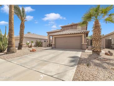 Inviting two-story home featuring desert landscaping, mature palm trees and a two car garage at 2859 E Cathy Dr, Gilbert, AZ 85296