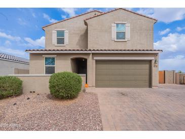 Charming two-story home featuring a two-car garage, desert landscaping, and a welcoming entrance at 37185 N Falabella Dr, San Tan Valley, AZ 85140