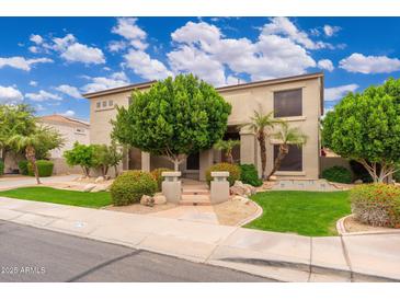 Inviting two-story home boasts mature trees, lush landscaping, and charming curb appeal at 1074 E Carla Vista Ct, Gilbert, AZ 85295