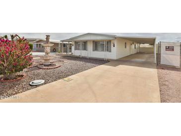 Charming home featuring a well-maintained front yard, beautiful water fountain, and covered parking at 110 S 72Nd Way, Mesa, AZ 85208