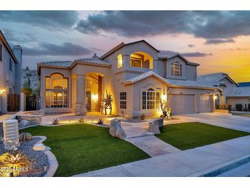 Inviting two-story home with a well-manicured front yard and beautiful desert landscaping and attached garage at 15413 S 31St Pl, Phoenix, AZ 85048