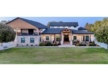 Expansive home with well manicured lawn, stylish accents and a welcoming entrance for luxurious living at 16322 E Fairview St, Gilbert, AZ 85295