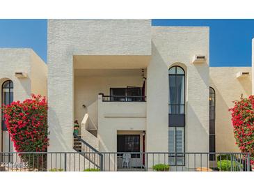 Condo exterior featuring a wrought iron fence and stairs leading to an upstairs unit with an outdoor seating area at 16739 E El Lago Blvd # 202, Fountain Hills, AZ 85268