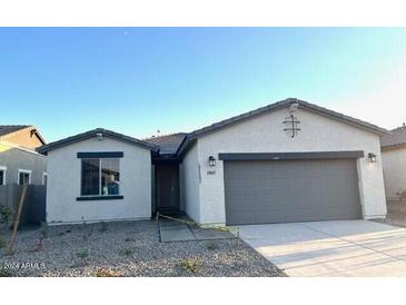 Charming single-story home with a two-car garage and a well-maintained front yard at 19045 W Rose Ln, Waddell, AZ 85355