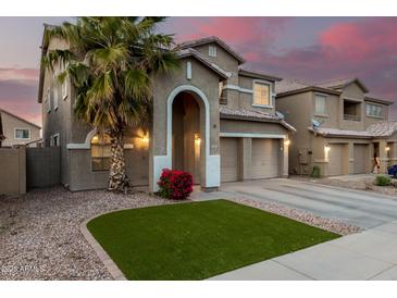 Charming home featuring a well-manicured yard, desert landscaping, and a welcoming arched entryway at 3882 W Goldmine Mountain Dr, San Tan Valley, AZ 85144