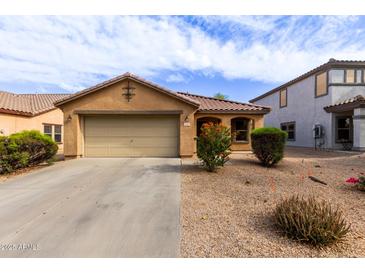 Charming single-story home with a two-car garage, desert landscaping and a cozy covered porch entrance at 749 E Desert Moon Trl, San Tan Valley, AZ 85143