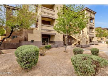 Attractive exterior of a multi-story building with well maintained landscaping, manicured bushes and decorative gravel at 10136 E Southern Ave # 1074, Mesa, AZ 85209