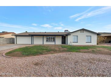 Charming single-story home with desert landscaping and a freshly painted exterior, exuding curb appeal at 1410 W Morrow Dr, Phoenix, AZ 85027