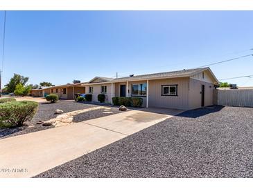 Charming single-story home with desert landscaping, gravel yard and walkway at 14842 N 36Th St, Phoenix, AZ 85032