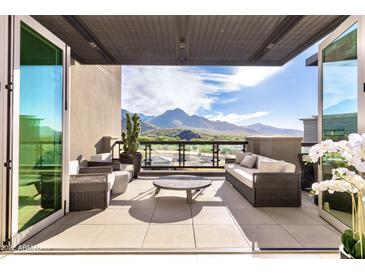 Expansive balcony featuring comfortable seating, offering breathtaking views of the surrounding desert landscape at 18720 N 101St St # 3006, Scottsdale, AZ 85255