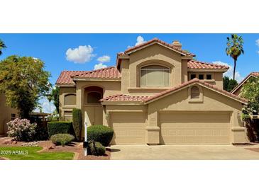 Lovely two-story home featuring a tile roof, neutral-toned exterior, an attached two-car garage, and well-maintained landscaping at 21538 N 59Th Ln, Glendale, AZ 85308