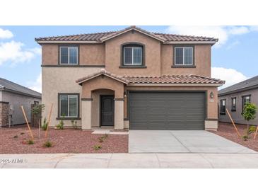 Inviting two-story home featuring a neutral stucco facade, tile roof, and a two-car garage in a modern design at 25147 W Atlanta Ave, Buckeye, AZ 85326