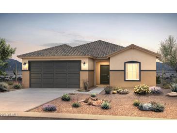 Charming single-story home with a well-manicured front yard and a two car garage at 25224 W Chanute Pass, Buckeye, AZ 85326