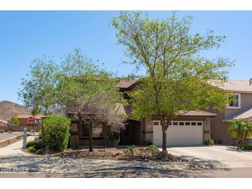Charming two-story home features a two car garage, desert landscaping, and mature shade trees at 29431 N 23Rd Dr Dr, Phoenix, AZ 85085