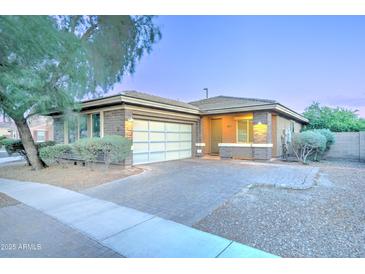 Charming single-story home with a two-car garage, brick accents, and a well-manicured front yard at 3153 E Ivanhoe St, Gilbert, AZ 85295