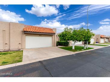 Charming single-story home with a white garage door and a well-manicured front yard at 3345 E University Dr # 73, Mesa, AZ 85213