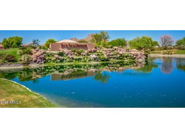 Scenic view of the San Tan Heights community entrance with a pond and lush landscaping at 34195 N Alison Dr, San Tan Valley, AZ 85144