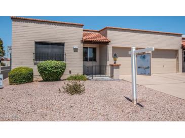 Charming single-story home with desert landscaping, tiled roof and inviting entrance at 4502 E Carol Ave # 1, Mesa, AZ 85206