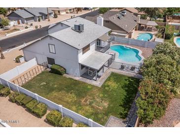 Aerial view of backyard with refreshing pool, well-kept lawn and shaded patio, perfect for outdoor living at 6237 W Altadena Ave, Glendale, AZ 85304