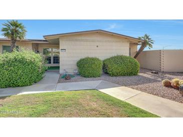 Charming single-story home with desert landscaping and a well-maintained front yard at 10713 W Santa Fe Dr, Sun City, AZ 85351