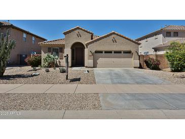 Charming single-story home with a desert-landscaped front yard and two car garage at 14214 W Ventura St, Surprise, AZ 85379