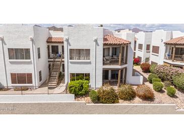 Condo complex featuring red tile roofs, stucco walls, patios, and desert landscaping against a mountain backdrop at 16616 E Gunsight Dr # 114, Fountain Hills, AZ 85268