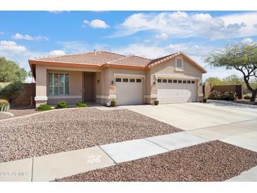 Charming single-story home with a three-car garage and well-maintained desert landscaping at 16876 W Stevenage St, Surprise, AZ 85374
