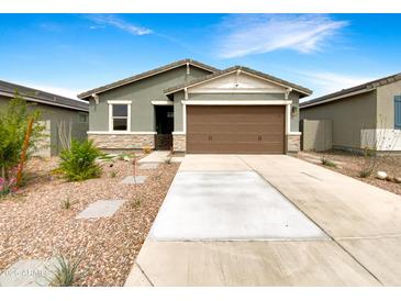 Charming single-story home with a well-manicured front yard and a two-car garage at 32341 N Union St, San Tan Valley, AZ 85143