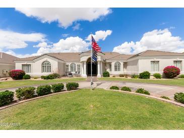 Stunning single-story home featuring a well-manicured lawn, elegant architecture, and a circular driveway at 3528 E Decatur St, Mesa, AZ 85213