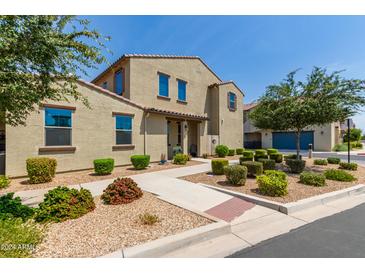 Charming two-story home featuring a neutral-toned facade, manicured landscaping, and a welcoming entryway at 3855 S Mcqueen Rd # 24, Chandler, AZ 85286