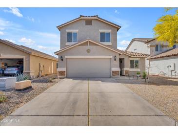 Charming two-story home featuring a spacious driveway and low-maintenance desert landscaping at 4559 E Sierrita Rd, San Tan Valley, AZ 85143